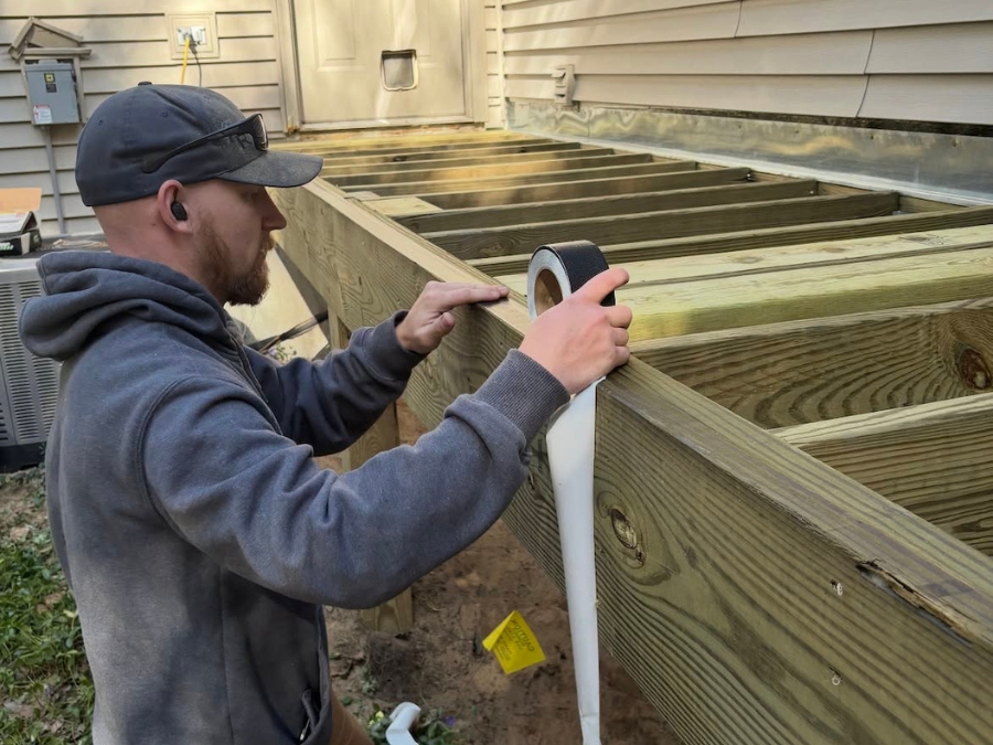 PR Design Builld employee measuring deck